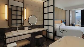 A modern hotel room with a large bed, a separate bathroom with a bathtub, a vanity with a mirror, and a city view through the window.