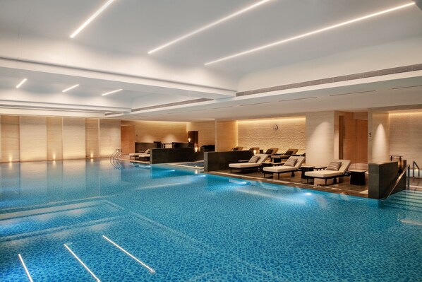 A large indoor swimming pool with lounge areas and modern lighting. - Sheraton Lanzhou Anning (Lanzhou)