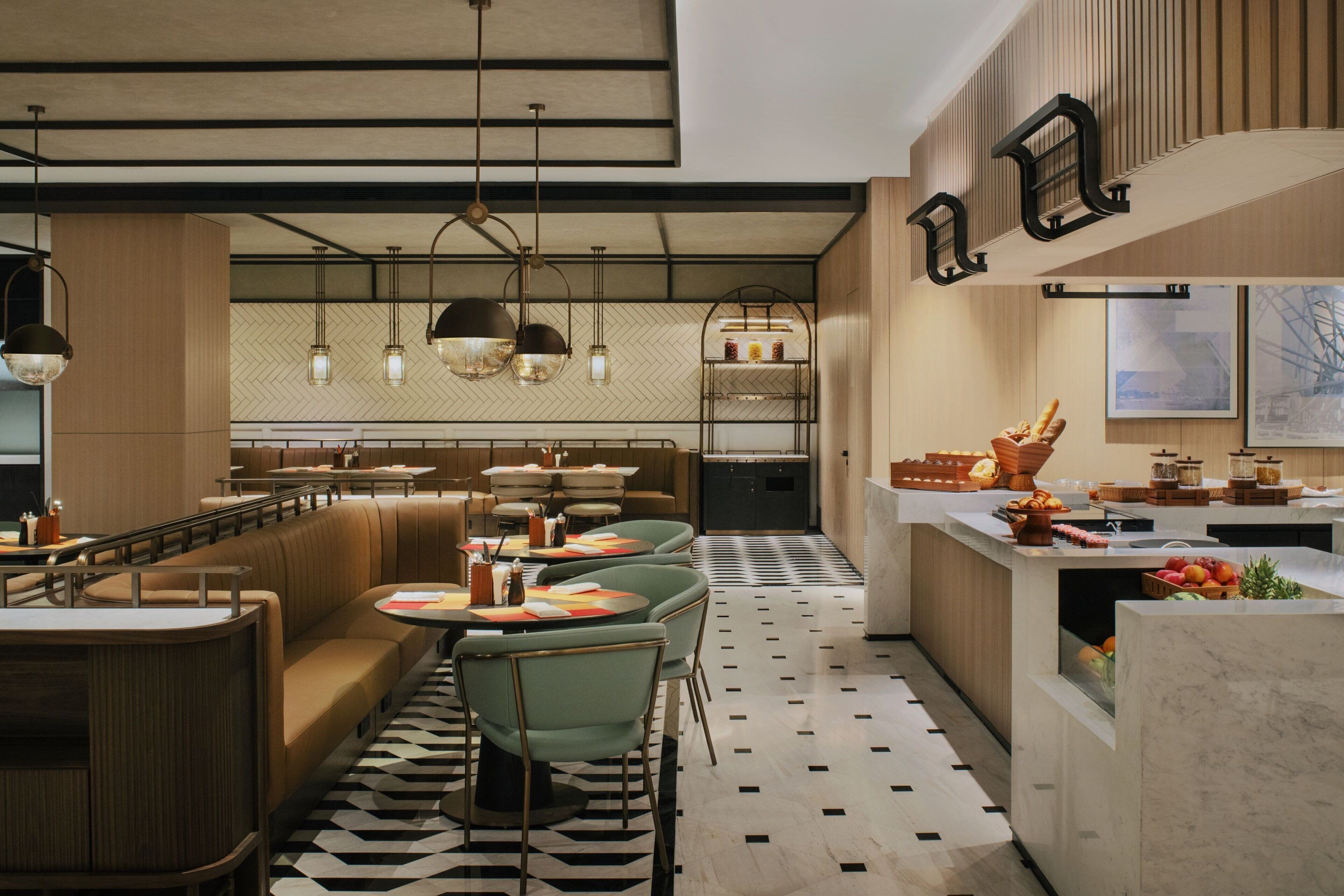 A modern restaurant with a central dining area, a bar, and a kitchen.