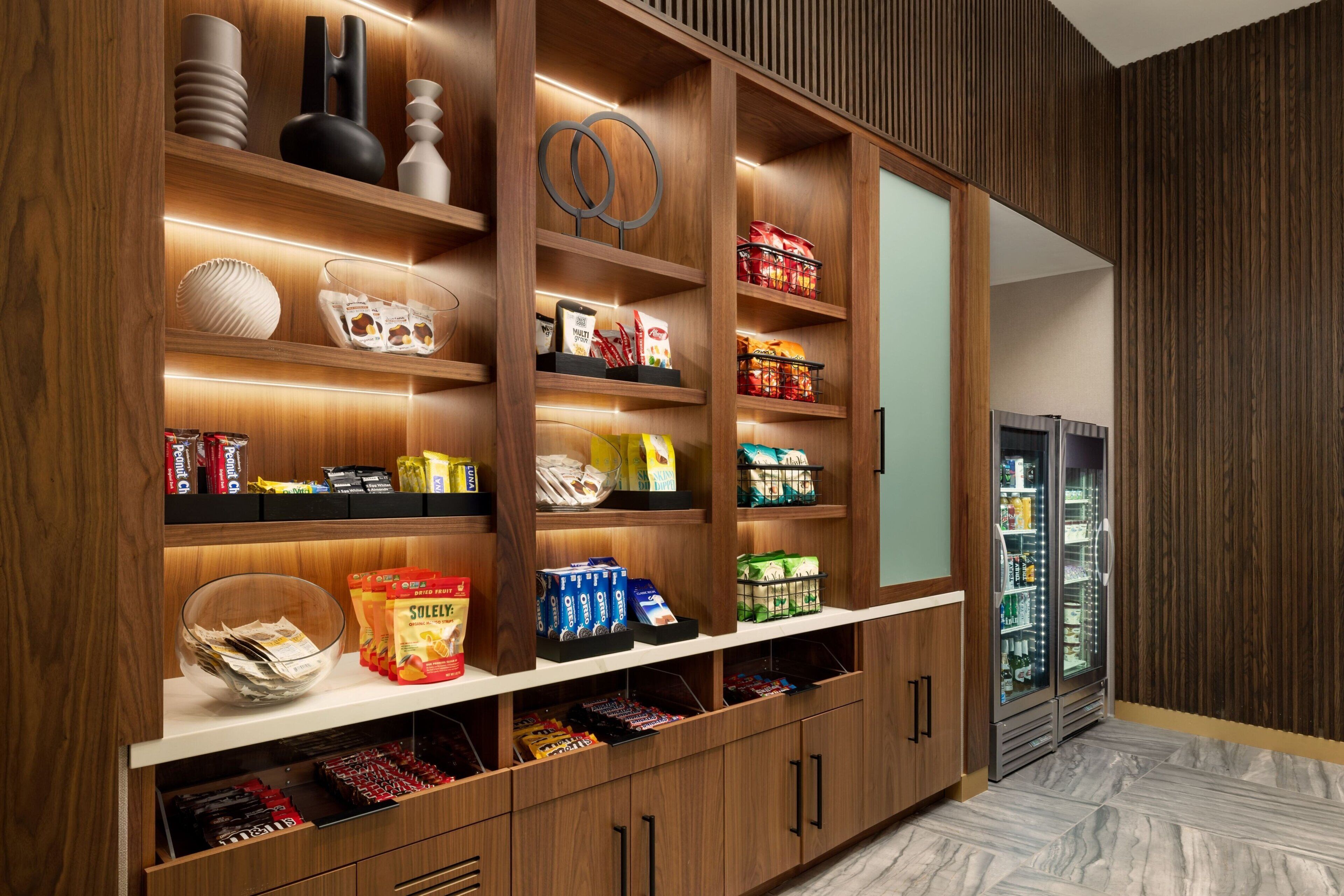 A well-organized pantry with various food items and kitchenware.