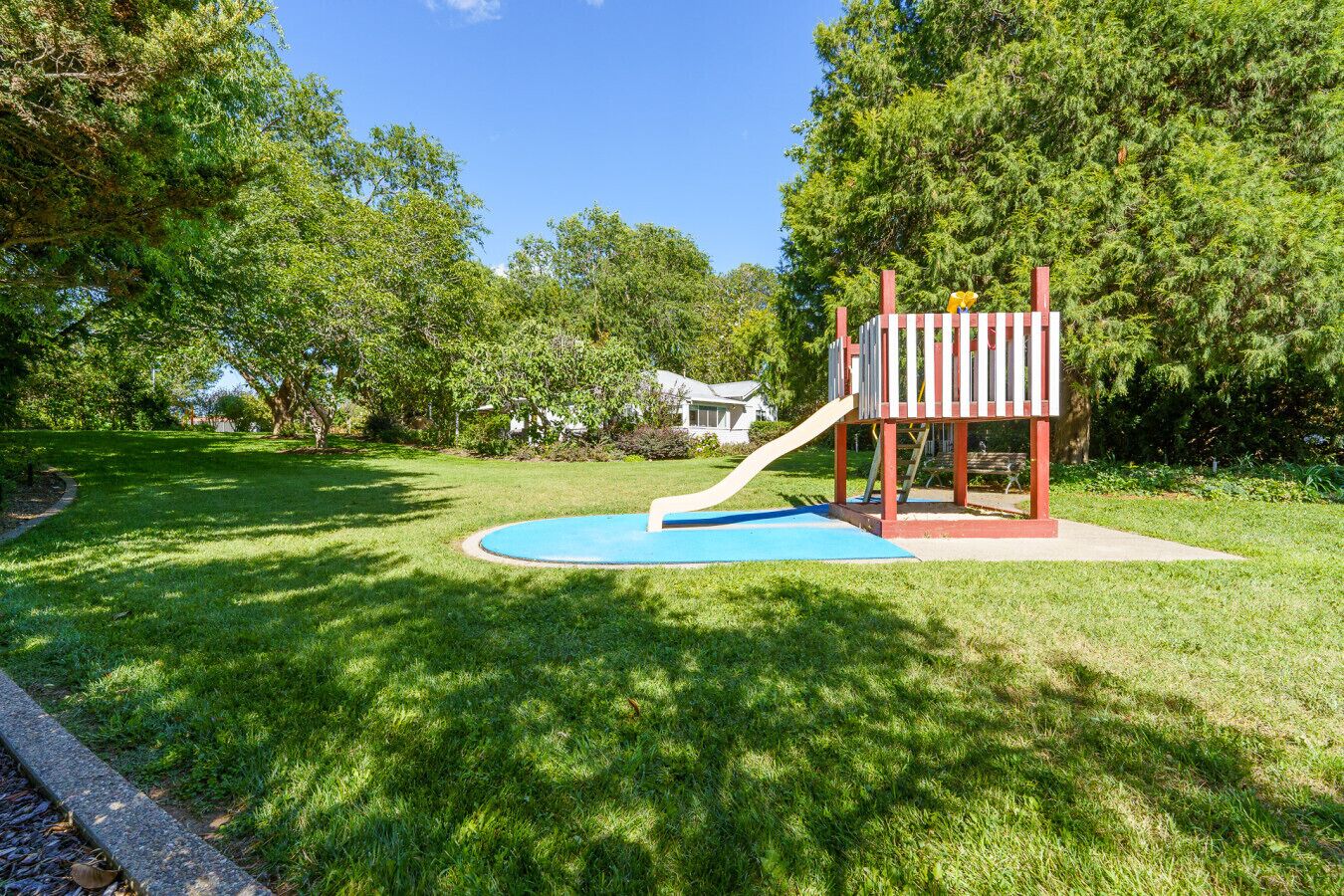A playground with a slide and a small pool.