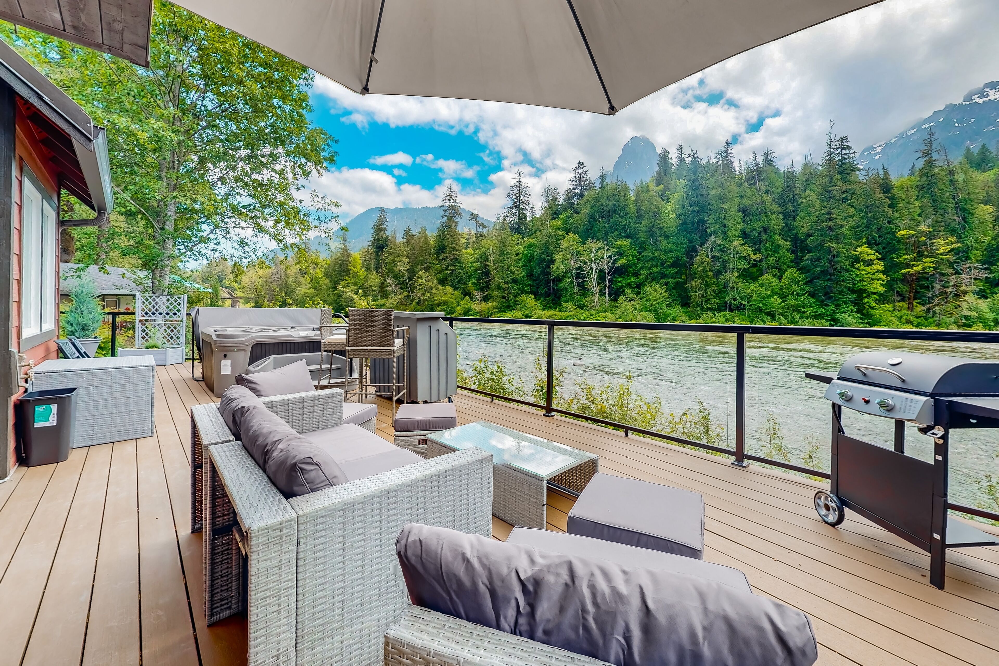 Modern riverfront home with hot tub, gas grill and patio