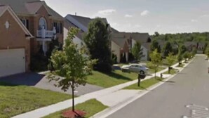A residential street with houses, a sidewalk, and a road with directional arrows. - Minutes from I495/200/95, DC and VA. Family sized guest suite with games to play (Silver Spring)