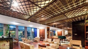 A spacious lobby with a high ceiling, comfortable seating areas, and a view of the outdoors through large windows. - Floral Hotel · YunFu City King Royal Hotel (Yunfu)