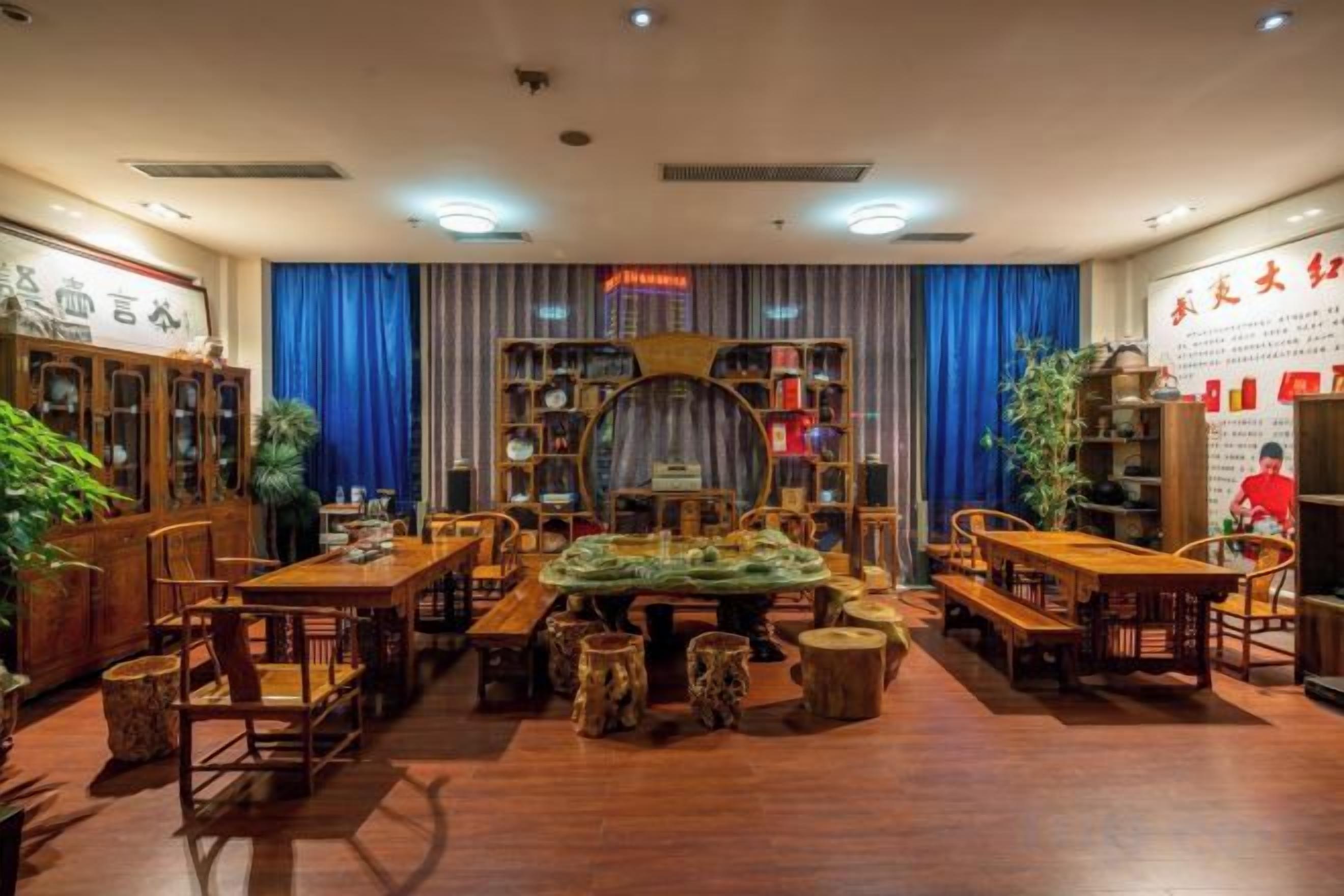 A traditional dining area with wooden furniture, a central table, and bookshelves.
