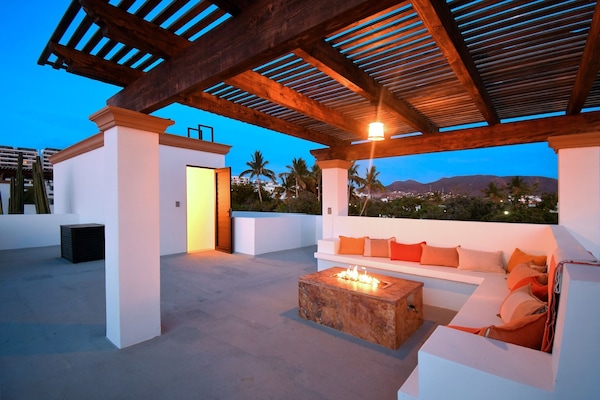 Fire pit and seating area on rooftop.