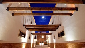 A corridor with wooden beams and brick walls, leading to a building entrance with a sign. - Gated 3BD+Office/flex bedroom, Sleeps 8, HTD Pool, Rooftop, 2 Blks to Malecon (La Paz)