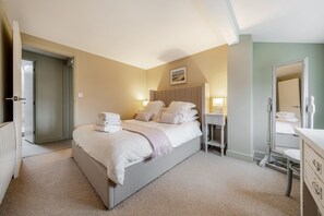 Experience comfort in this well-appointed room with a large bed, bedside table, and convenient amenities.