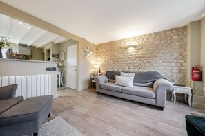 Relax in this stylish living room with a grey sofa, armchair, and neutral decor.