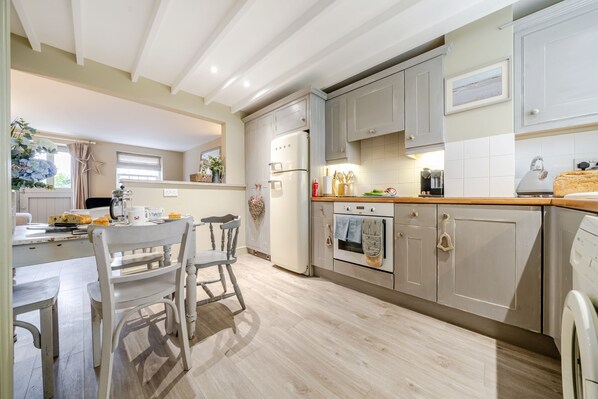 Enjoy cooking in this well-equipped kitchen with a central island, oven, and ample counter space.