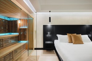 A modern bedroom with a large bed, a bedside table, and a built-in bench with a glass partition. - Dream Suite Trevi (Rome)