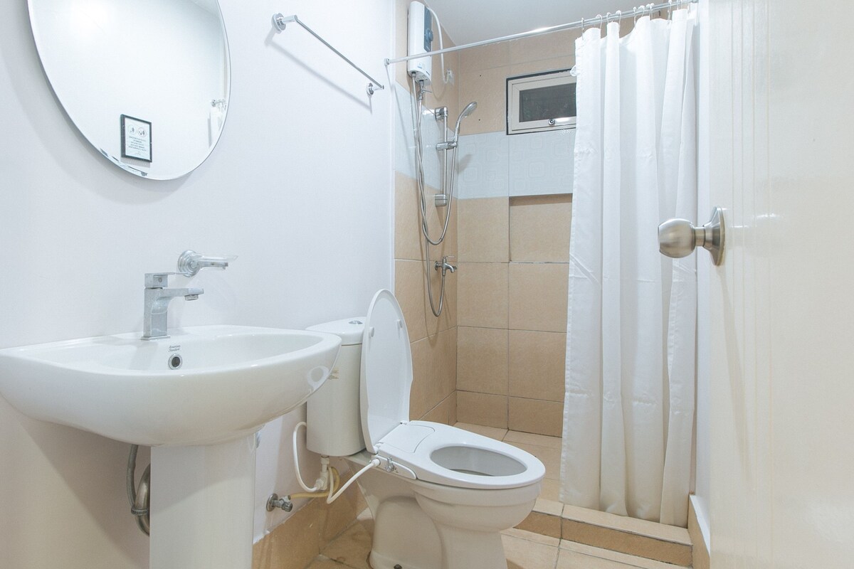 A bathroom with a sink, toilet, and shower.