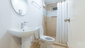 A bathroom with a sink, toilet, and shower. - Catlea Inn (Pasay)
