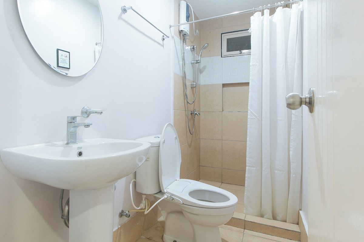 A bathroom with a sink, toilet, and shower.