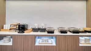 A buffet setup with various food dispensers and containers. - elan hotel(Wulinmen Subway Station Hangzhou Xihu) (Hangzhou)