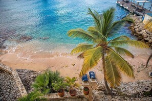 Relax on the pristine beach with lounge chairs and enjoy the tranquil atmosphere.
