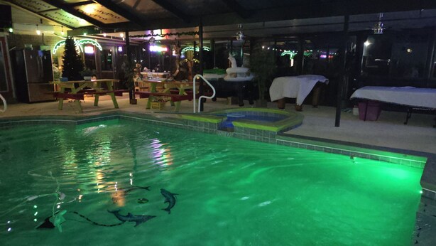 Une piscine intérieure à l’eau claire, dotée d’un plongeoir et d’un petit toboggan.