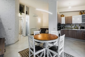 Apartment, Garden View | Living area | 35-inch Smart TV with digital channels