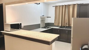 A modern kitchen with a built-in microwave, a gas stove, and a stainless steel refrigerator. - Modern apartment for rent in La Gaulette.
Suitable for couple or family. (La Gaulette)
