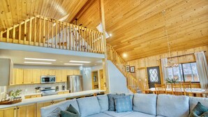 A spacious loft-style living area with a wooden ceiling, a kitchen with modern appliances, and a cozy seating area. -  Quiet Mountain Cabin Getaway (Pinetop)