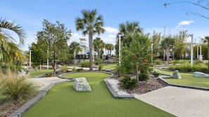 A well-maintained golf course with manicured lawns, stone pathways, and a variety of trees and shrubs. - Last Minute Disney Getaway! Villa with Private Pool & Hot Tub. Book Now! #112595 (Orlando)
