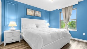 A bedroom with a white bed, blue walls, and a window with curtains. - Last Minute Disney Getaway! Villa with Private Pool & Hot Tub. Book Now! #114161 (Orlando)