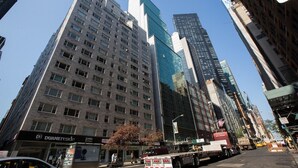 A high-rise urban building with multiple floors, large windows, and a mix of modern and older architectural styles. - New York City | Midtown Escape | Near Central Park & Broadway (New York)