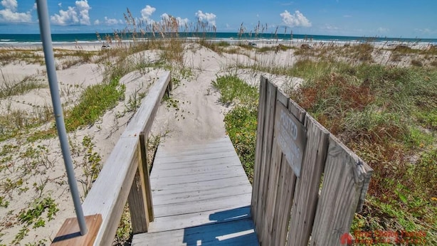 A wooden boardwalk leading to a beach with a clear sky. - Direct Oceanfront ~ Private Walkway ~ Excellent Rates! (Saint Augustine)
