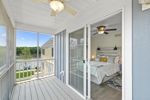 A bedroom with a bed, bedside table, and a ceiling fan. - On Cloud Wine (Ottawa)