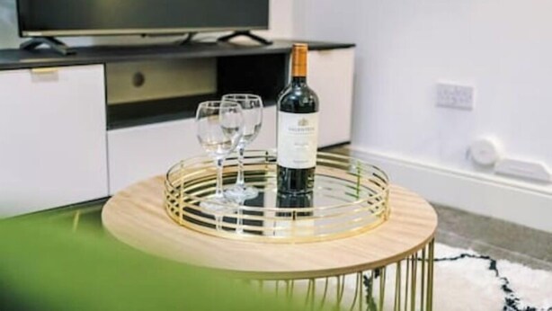 A room with a round table, a bottle of wine, and two glasses. - Old Dutch Embassy by Guestz (Kingston-upon-Hull)
