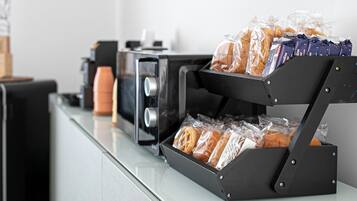 A breakfast station with a bread display and a coffee machine.