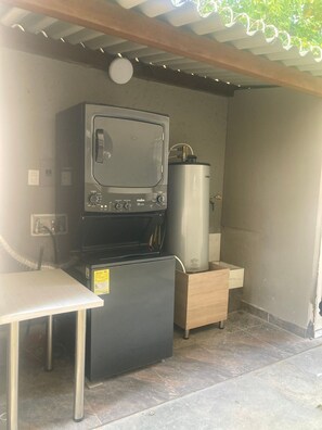 Enjoy meal preparation and cleaning in this compact kitchen with microwave oven and sink.