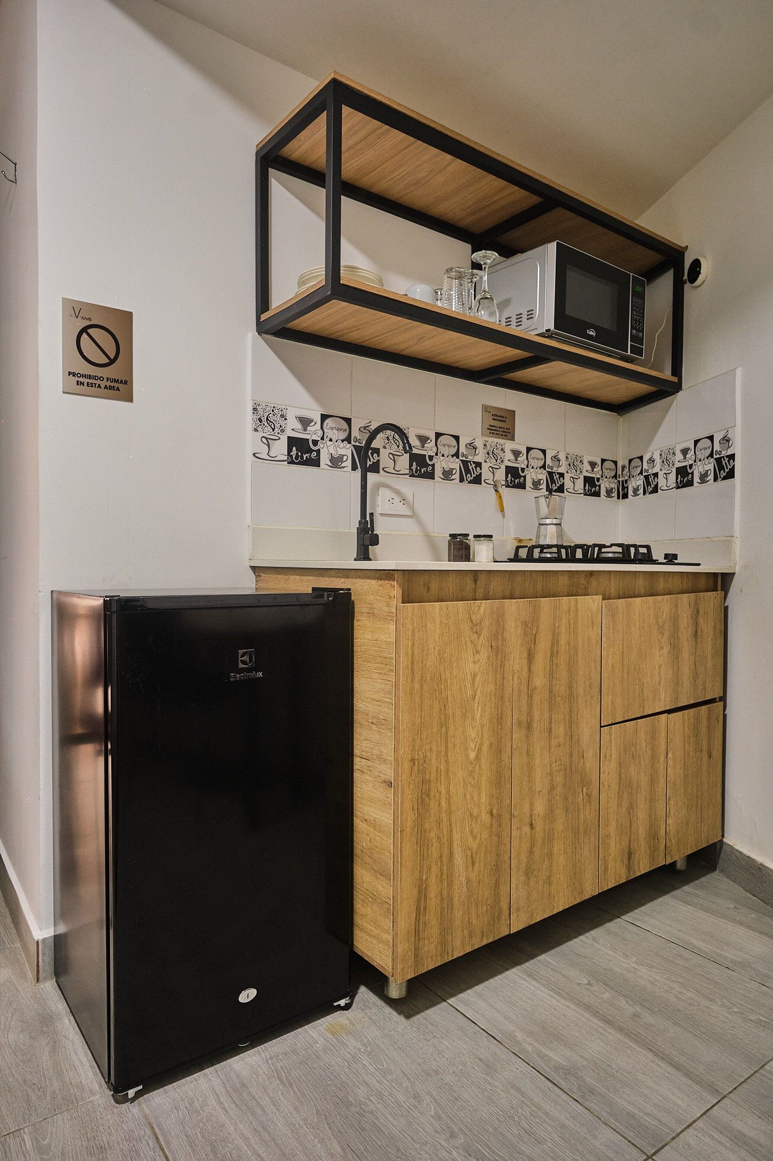 Fridge, microwave, coffee/tea maker, cookware/dishes/utensils