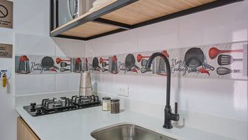 Fridge, microwave, cookware/dishes/utensils, dining tables