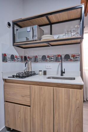 Fridge, microwave, cookware/dishes/utensils, dining tables
