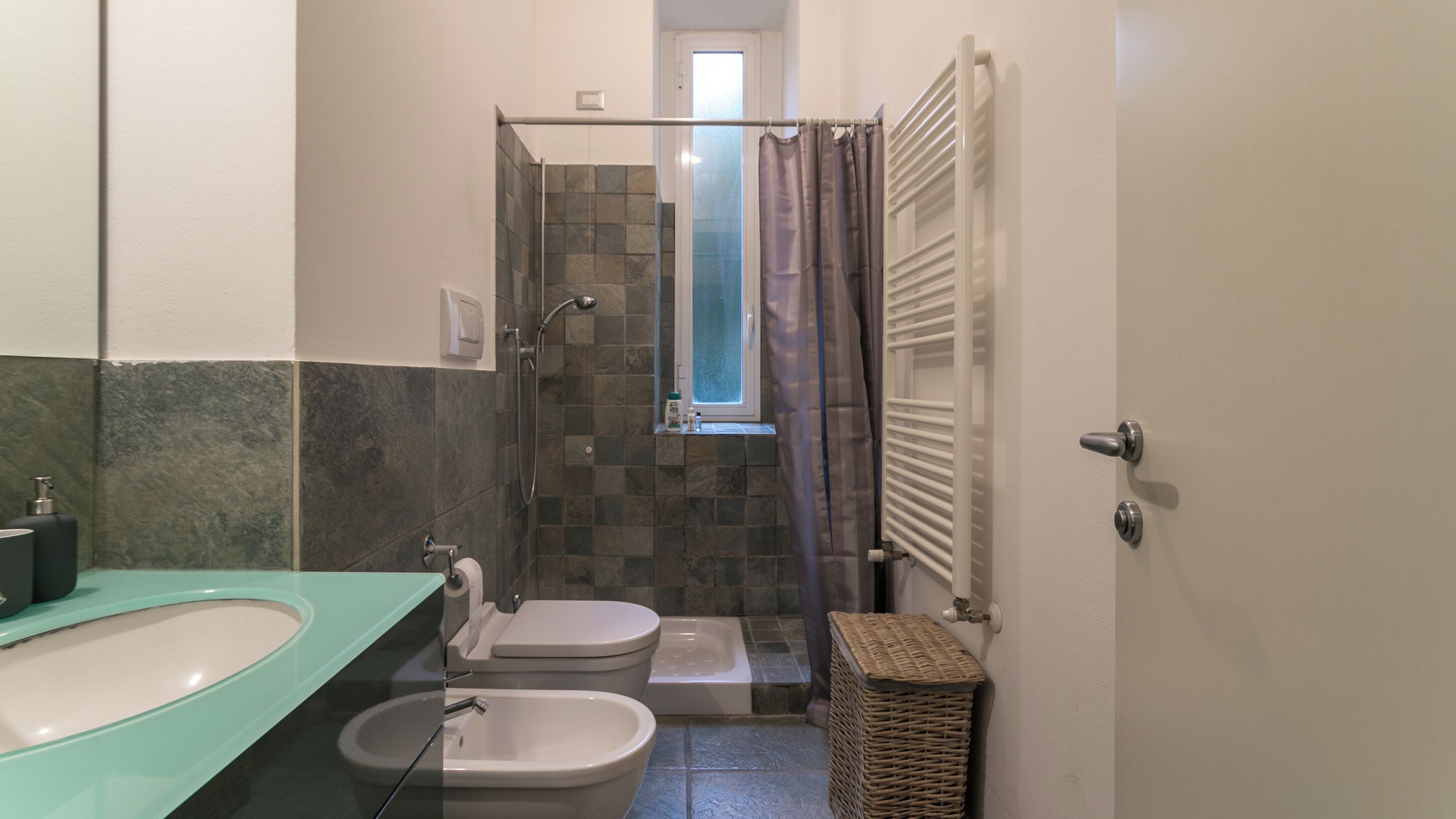 Ein Badezimmer mit Dusche, Toilette und Waschbecken.