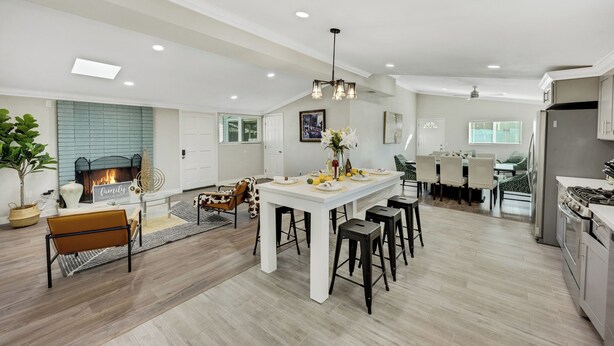 A spacious kitchen with a central island, modern appliances, and a dining area with chairs and a table. - BOOK NOW!!! Your vacation awaits your home for Disneyland and OC destinations. (Anaheim)