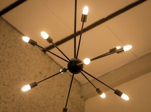 A ceiling light fixture with multiple bulbs arranged in a radial pattern.