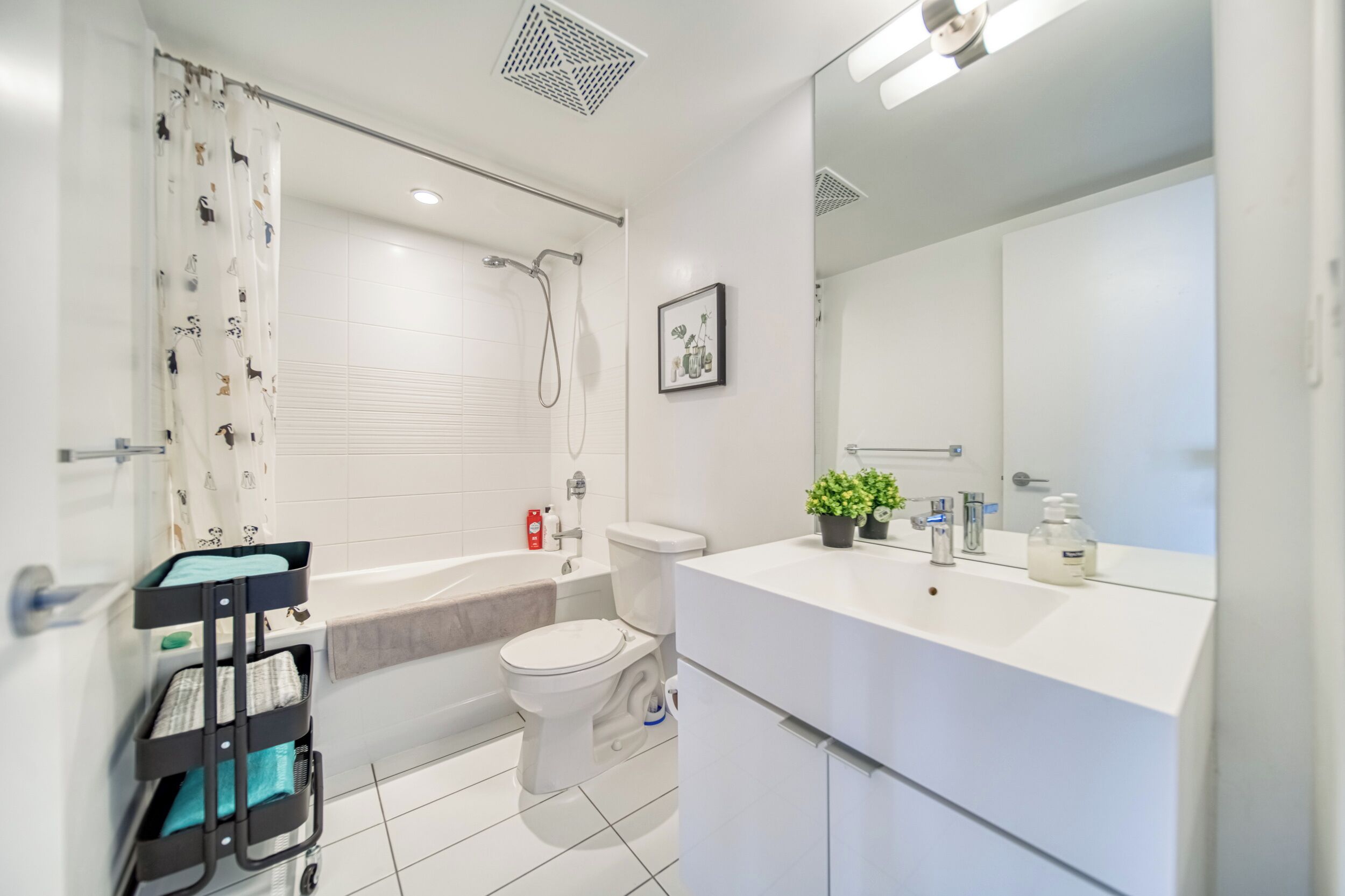 A modern bathroom with a bathtub, toilet, and sink.