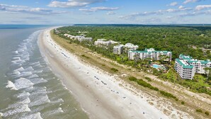 A coastal hotel with multiple buildings, a sandy beach, and a view of the ocean. - 4205 Windsor @ Palmetto Dunes | Oceanfront Villa | Pool & Spa | Moments to Beach (Hilton Head Island)