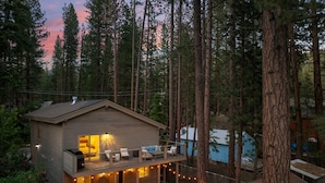 A cabin with a balcony, surrounded by tall trees and a pool. - One Block to Beach, Restaurants, Bars, Brewery. Modern mountain luxury. (Kings Beach)