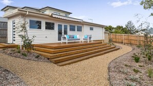 A single-story house with a covered porch, a small garden area, and a wooden deck. - Quiet, luxurious Guest House - Couples Retreat (Mornington)