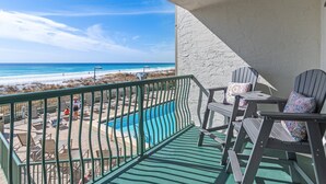 A balcony with a view of the beach and ocean, outdoor seating, and a pool. - Updated 1 Bed/1 Bunk Beachfront Condo with Spectacular Gulf Views! (Destin)