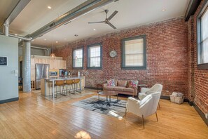A spacious living area with a kitchen, a sofa set, and a dining area.