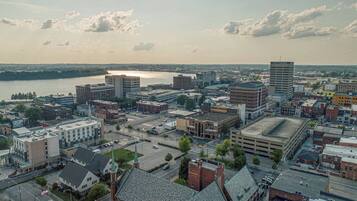 A cityscape with a mix of modern and historic buildings, a river in the background, and a clear sky.