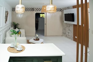 Design Condo, Garden View, Poolside | Living area | 32-inch flat-screen TV with digital channels, pay movies, heated floors