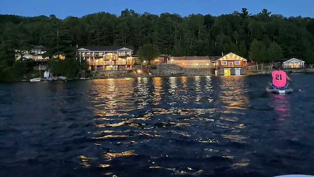 A waterfront property with multiple buildings, a dock, and a sign indicating a speed limit of 21. - Charming castle with 7 bedrooms and WiFi, AC in Coe Hill (Coe Hill)