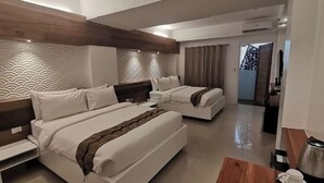 A modern hotel room with two beds, a wooden accent wall, a patterned headboard, and a view of the outside. - The Paragon Boracay Suites (Boracay Island)