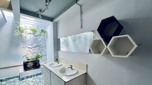 A modern bathroom with two sinks, a large mirror, and hexagonal shelves. - AULE HOSTEL (Ho Chi Minh City)