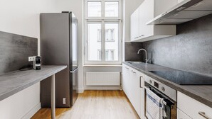 A modern kitchen with a built-in refrigerator, oven, and sink.